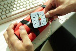 Close-up of businessman preparing bomb in office