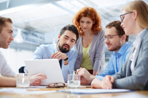 Angle view of a business team discussing the future of their company on the foreground