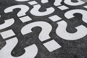 question mark signs painted on a asphalt road surface