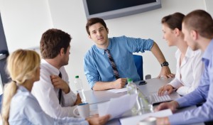 Group of happy young business people in a meeting at office