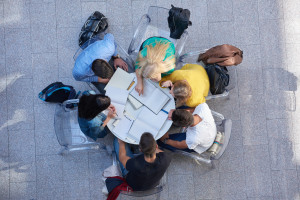 top view, group of students together at school table working homework and have fun